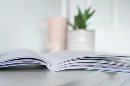 Booklet on table with vase