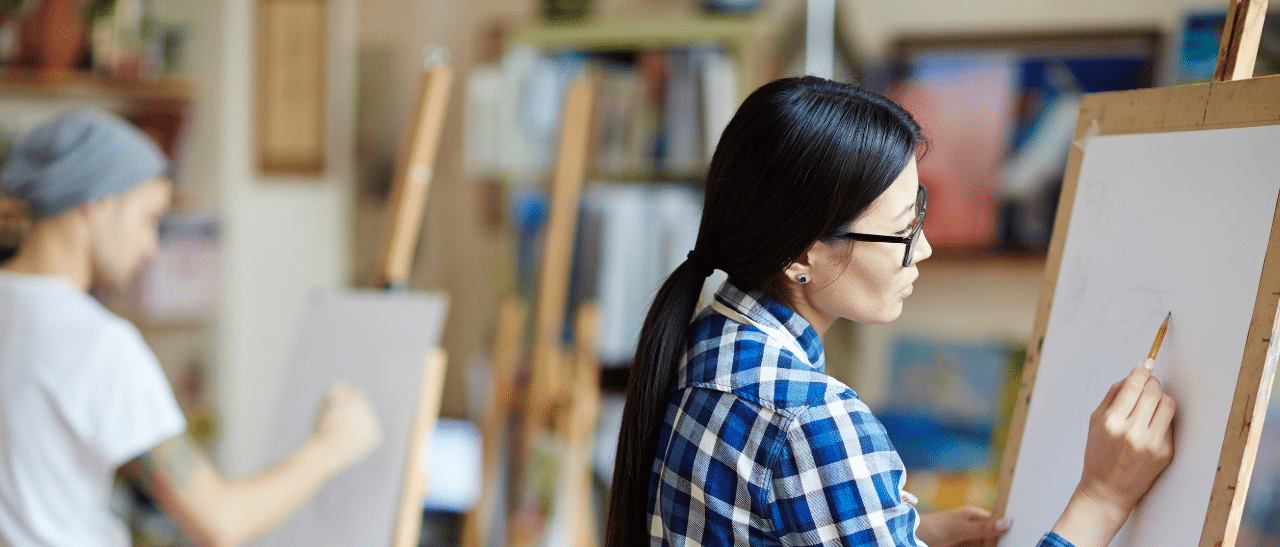 Two artists in a studio, sketching.
