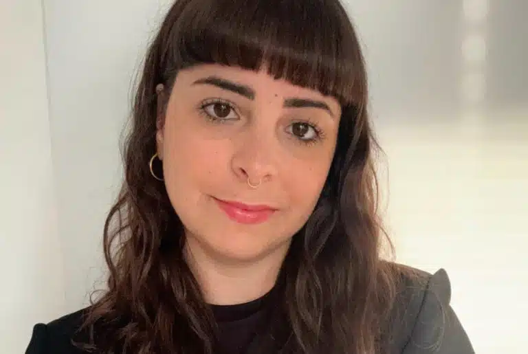 Photo of woman with dark hair and bangs facing camera
